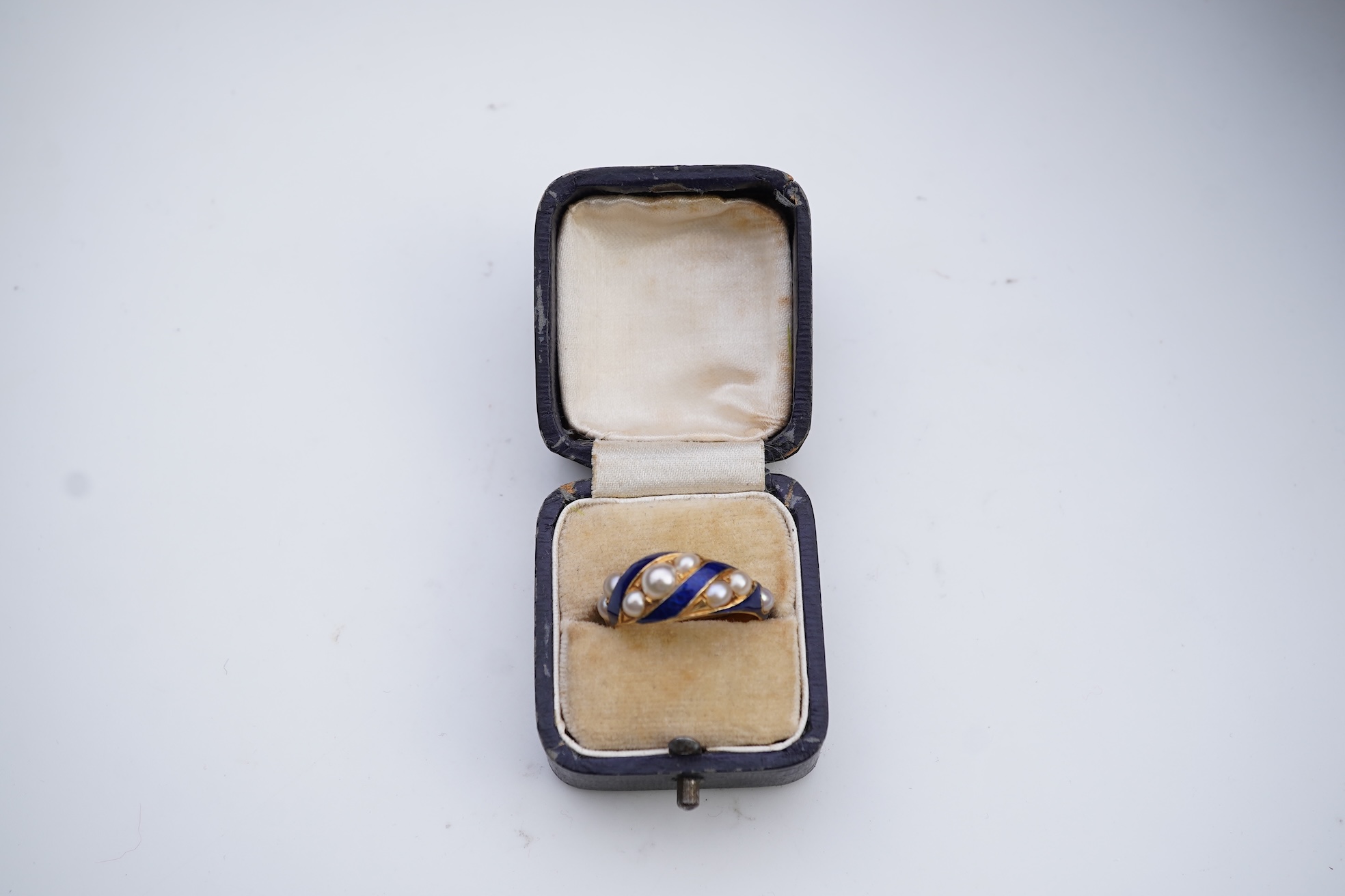 A Victorian half pearl and blue enamel ring, mid 19th century
